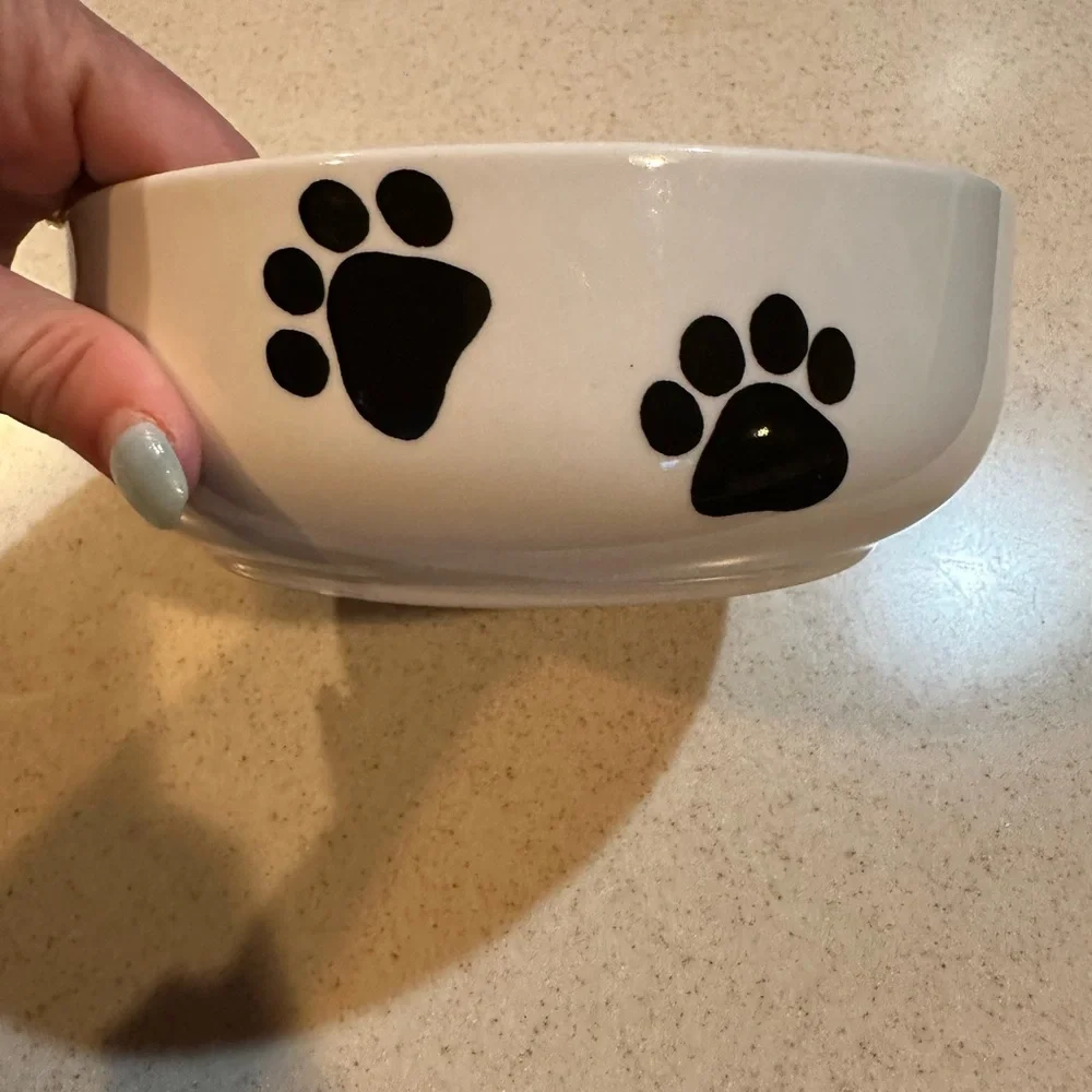 Rosalinde white dog bowl with Rottweiler and paw prints decor. Good shape.